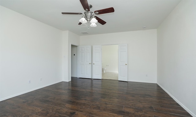 unfurnished bedroom featuring ceiling fan, dark wood-type flooring, visible vents, and baseboards