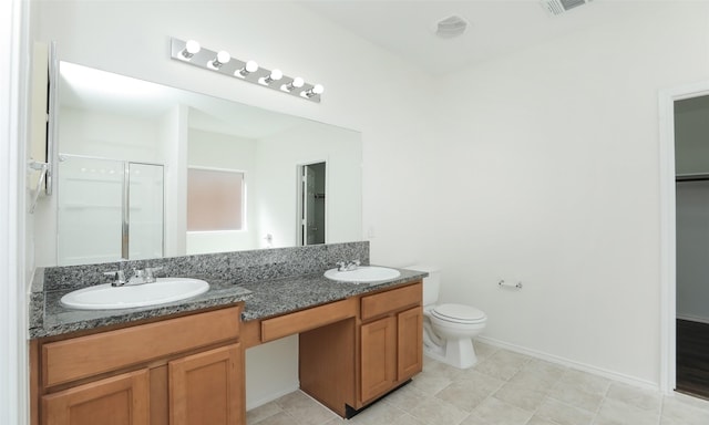 full bath with double vanity, a shower stall, toilet, and a sink