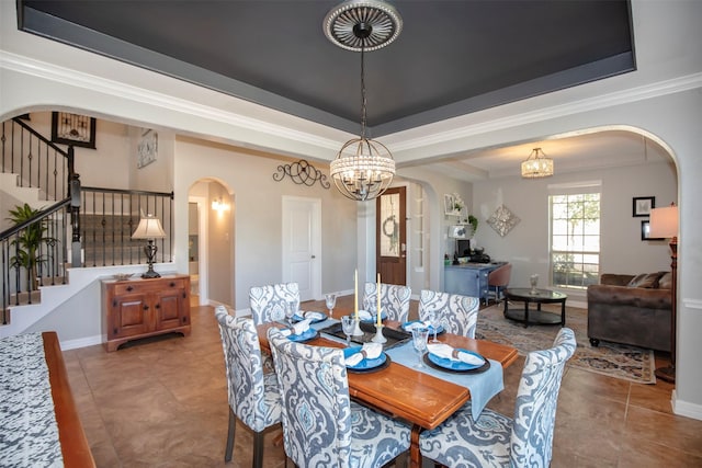 tiled dining area with arched walkways, a raised ceiling, and stairs