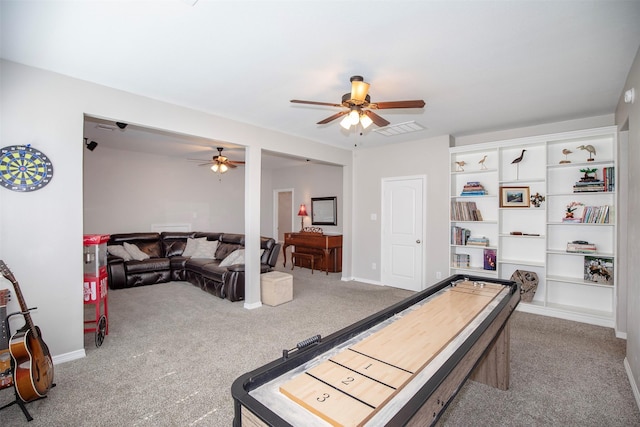 playroom featuring ceiling fan, carpet flooring, visible vents, and baseboards