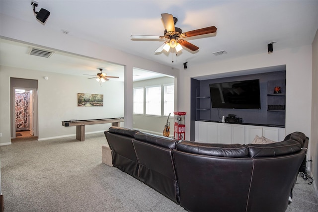 living area featuring a ceiling fan, carpet, visible vents, and baseboards