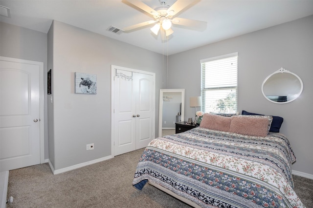 carpeted bedroom featuring a ceiling fan, a closet, visible vents, and baseboards