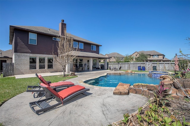 view of swimming pool featuring a fenced backyard, an in ground hot tub, a lawn, a fenced in pool, and a patio area