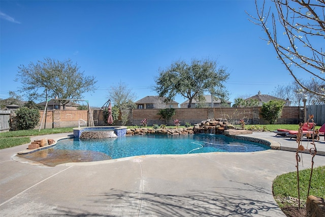 view of swimming pool with a pool with connected hot tub, a patio area, and a fenced backyard