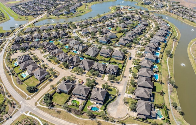 drone / aerial view with a water view and a residential view