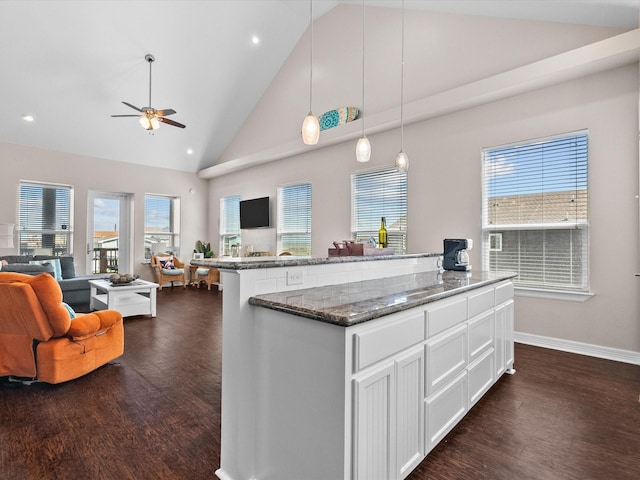 1922 Blue Water Hwy, Surfside Beach, TX 77541 - kitchen featuring open floor plan, dark wood finished floors, a ceiling fan, high vaulted ceiling, and white cabinetry
