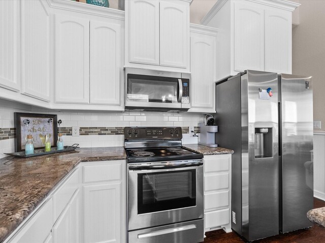 1922 Blue Water Hwy, Surfside Beach, TX 77541 - kitchen with stainless steel appliances, white cabinets, tasteful backsplash, and dark stone countertops