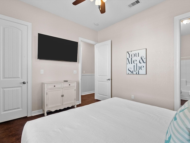 1922 Blue Water Hwy, Surfside Beach, TX 77541 - bedroom featuring baseboards, connected bathroom, ceiling fan, and dark wood-style flooring