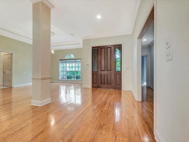 entrance foyer featuring decorative columns, baseboards, crown molding, light wood-style floors, and recessed lighting