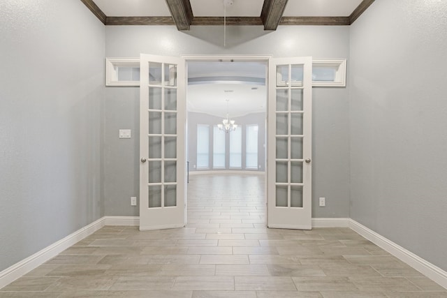 spare room with french doors, wood finish floors, beam ceiling, and baseboards