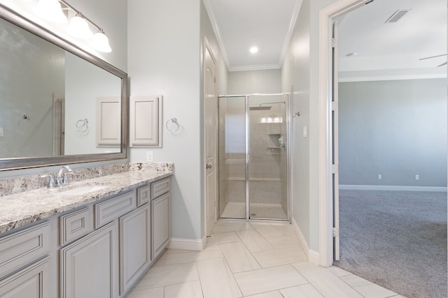 full bath with visible vents, vanity, baseboards, ornamental molding, and a shower stall