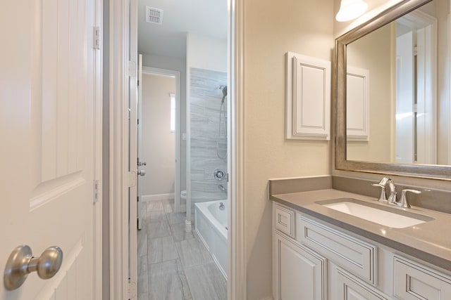 bathroom with visible vents, vanity, and toilet