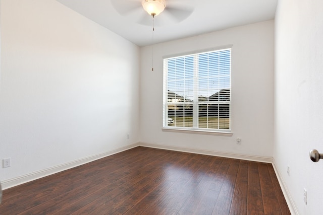 empty room featuring ceiling fan, dark wood-style flooring, and baseboards