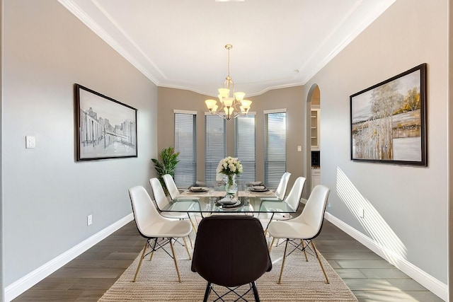 dining room featuring crown molding, baseboards, and wood finished floors