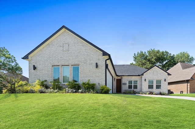 view of front of property with brick siding and a front yard