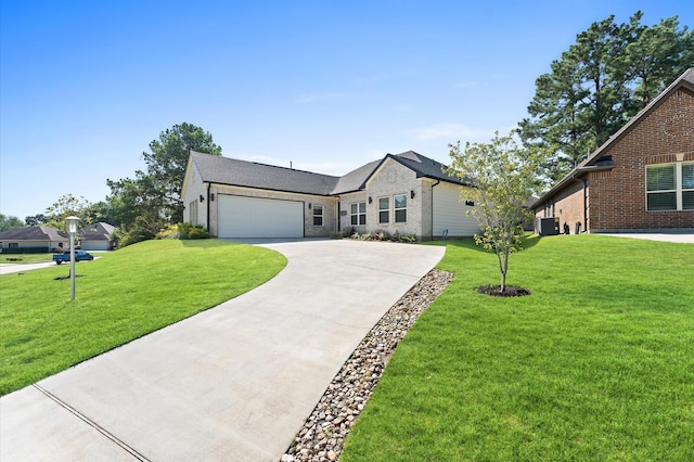 view of front of house with a garage, a front lawn, and concrete driveway