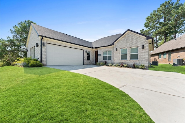 view of front of house with a garage, driveway, cooling unit, and a front yard