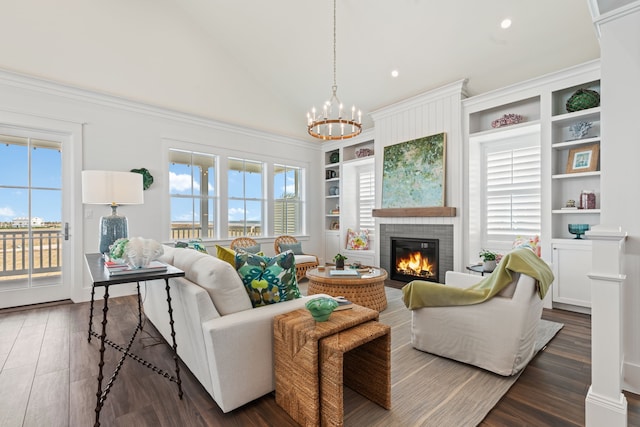 living area featuring lofted ceiling, a brick fireplace, dark wood-type flooring, and a wealth of natural light