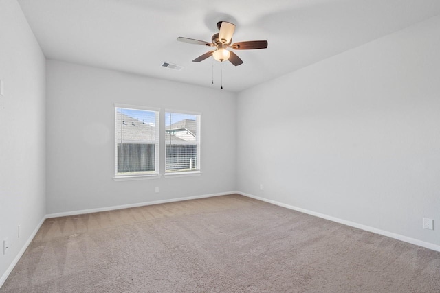 unfurnished room featuring carpet, visible vents, ceiling fan, and baseboards