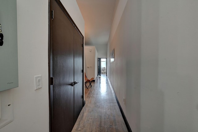 hall with light wood finished floors and baseboards