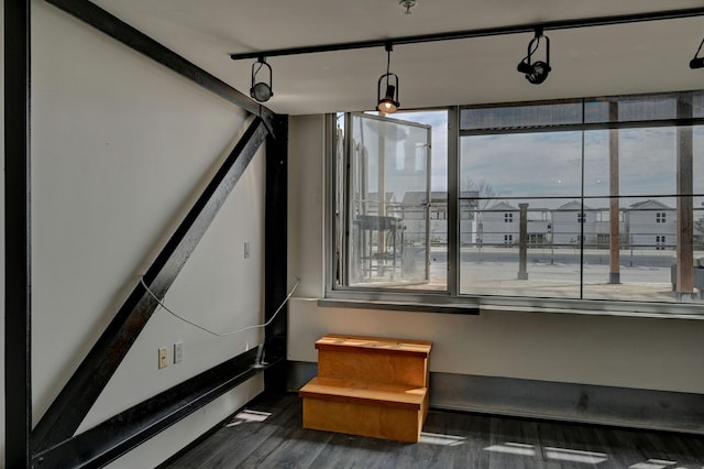 interior space with rail lighting and wood finished floors