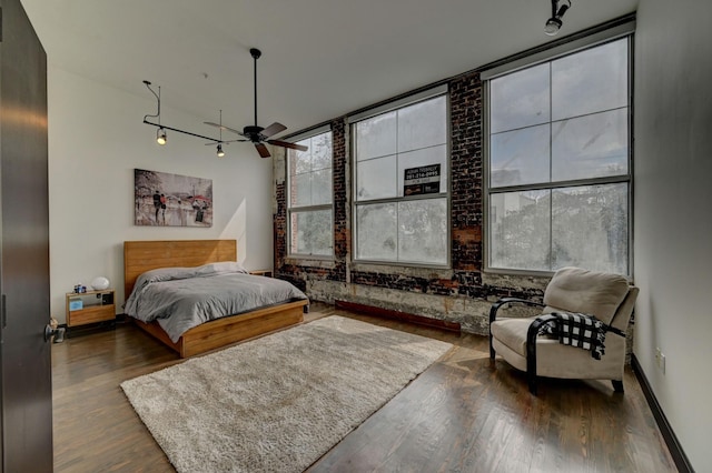 bedroom with wood finished floors and baseboards