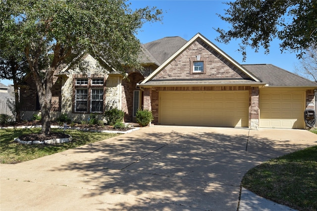 view of front facade with brick siding, a shingled roof, a garage, stone siding, and driveway