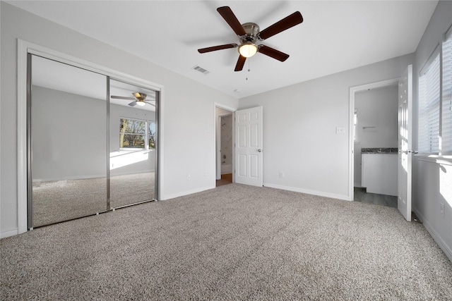 unfurnished bedroom featuring visible vents, baseboards, a ceiling fan, carpet, and a closet