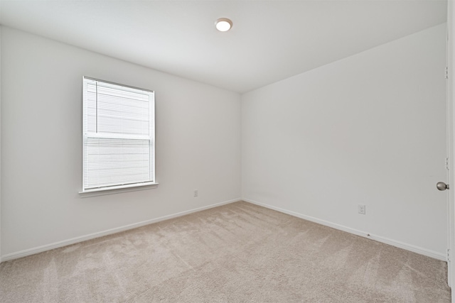 carpeted spare room with baseboards