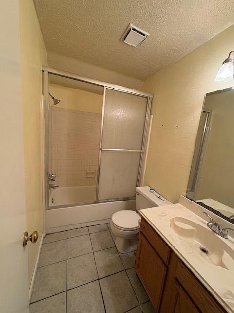 9427 Walnut Glen Dr, Houston, TX 77064 - full bathroom featuring tile patterned flooring, vanity, visible vents, and a textured ceiling