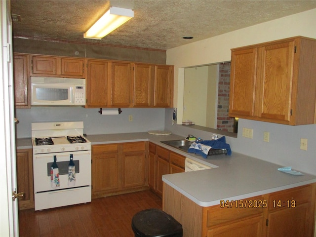 9427 Walnut Glen Dr, Houston, TX 77064 - kitchen with a sink, light countertops, white appliances, a peninsula, and dark wood-type flooring