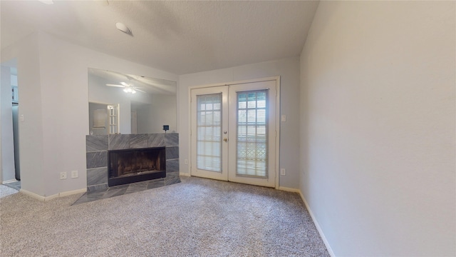 2323 Fairwind Rd Unit 860, Houston, TX 77062 - unfurnished living room featuring carpet floors, a tile fireplace, french doors, and baseboards