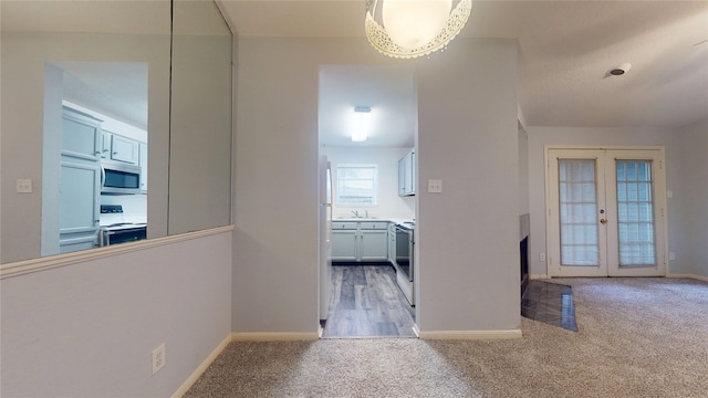 2323 Fairwind Rd Unit 860, Houston, TX 77062 - hallway featuring carpet floors, french doors, and baseboards