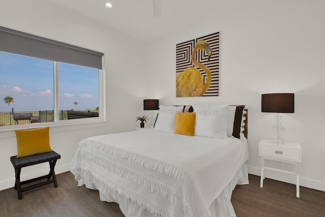 bedroom with recessed lighting, wood finished floors, and baseboards