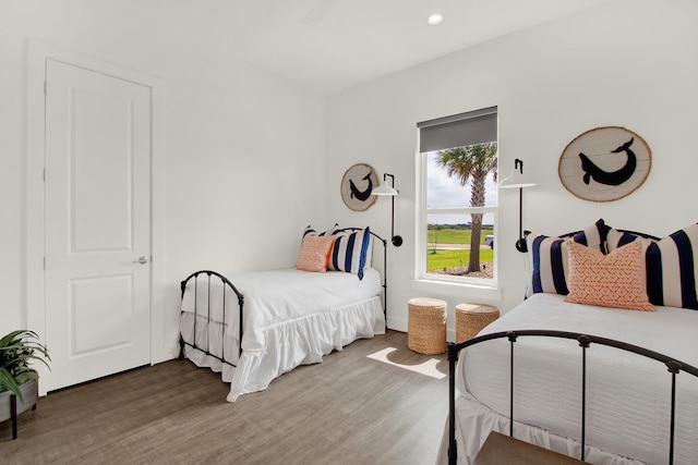 bedroom with recessed lighting and wood finished floors