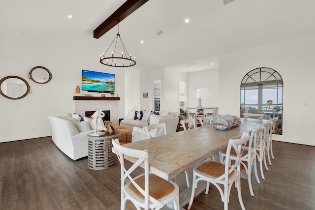 dining area featuring lofted ceiling with beams, dark wood-style floors, an inviting chandelier, a fireplace, and recessed lighting