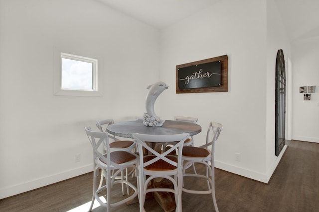 dining room with baseboards and dark wood-type flooring