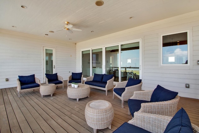 wooden terrace featuring an outdoor living space and a ceiling fan