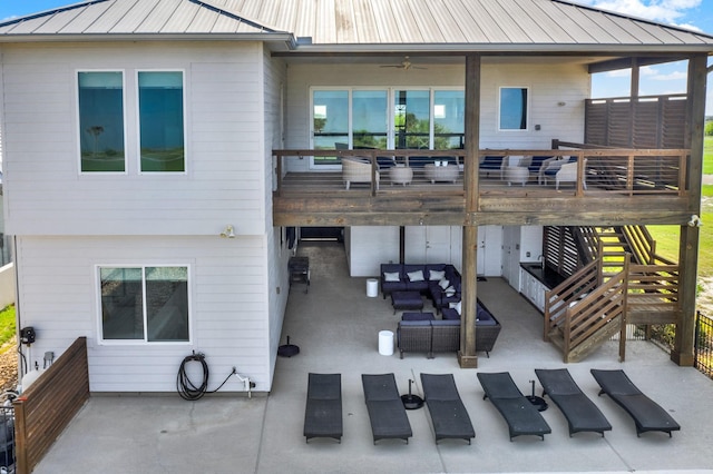 back of property featuring a standing seam roof, metal roof, a patio, and an outdoor living space