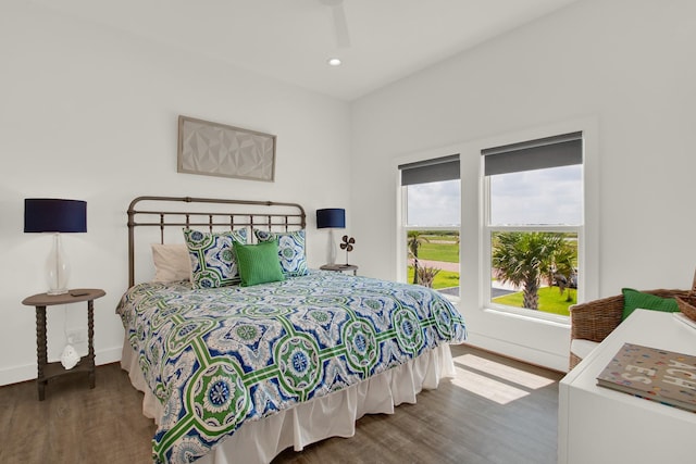 bedroom with recessed lighting, wood finished floors, and baseboards