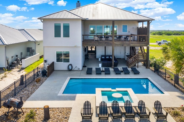 rear view of house featuring a patio, an outdoor hangout area, metal roof, a fenced backyard, and stairs