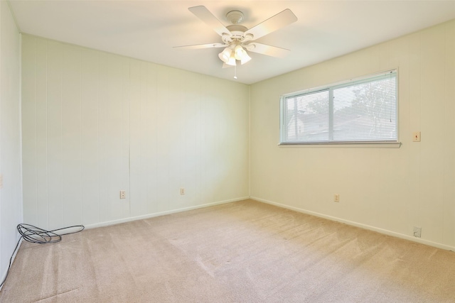 spare room featuring ceiling fan, baseboards, and carpet flooring