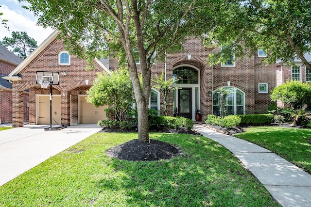 view of front of home with a garage, concrete driveway, brick siding, and a front lawn