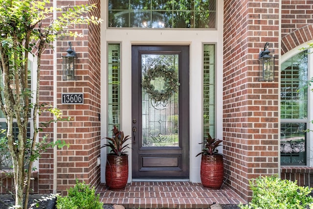 entrance to property featuring brick siding