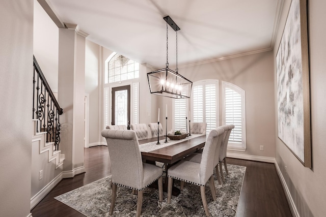 dining space with plenty of natural light, crown molding, dark wood-style flooring, and stairs