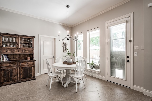 dining area with an inviting chandelier, baseboards, ornamental molding, and tile patterned flooring