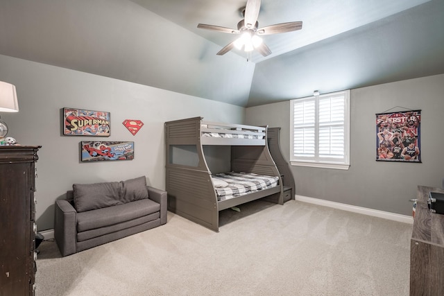 carpeted bedroom featuring vaulted ceiling, baseboards, and ceiling fan