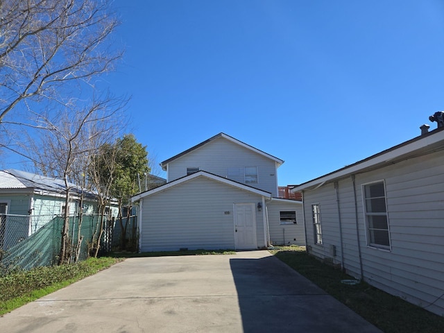 view of property exterior with a patio area and fence