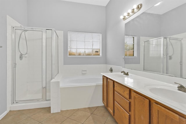 full bath with tile patterned flooring, a sink, and a shower stall