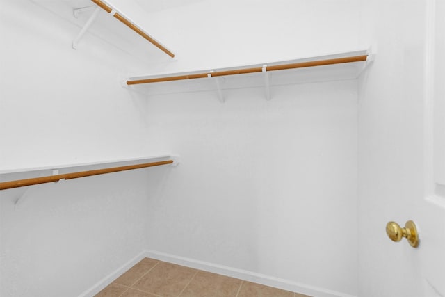 spacious closet featuring light tile patterned floors